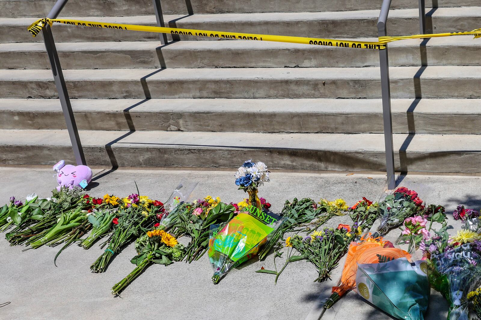 Flowers placed by students sit near police tape near the Florida State Student Union building, Tallahassee, Fla., Friday, April 18, 2025. (AP Photo/Gary McCullough)