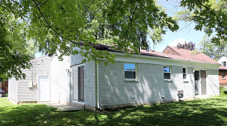 Patio doors from the kitchen open to a side patio while patio doors from the main bedroom open to the back yard.