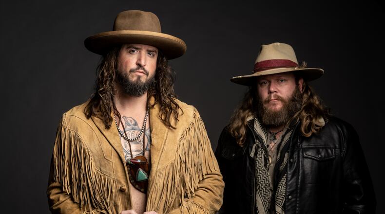 Cincinnati native Donnie Reis (right) and Scooter Brown of Nashville-based country act War Hippies, opening for Travis Tritt at Hobart Arena in Troy on Thursday, March 30, are both former military and combat veterans. CONTRIBUTED