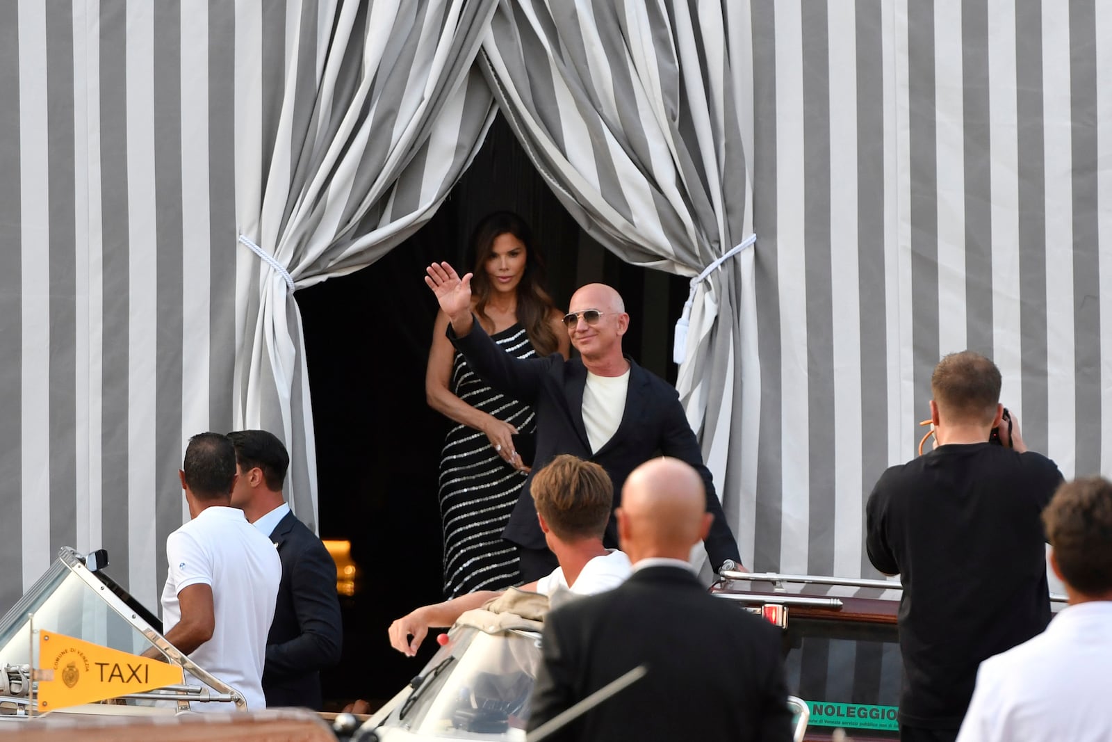 Amazon multi-billionaire founder Jeff Bezos, right, and Lauren Sanchez leave a hotel in Venice, Italy, on Wednesday, June 25, 2025, ahead of festivities in the lagoon city reportedly linked to their wedding. (AP Photo/Luigi Costantini)