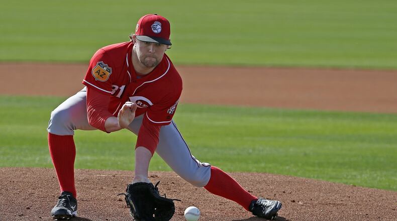 Cincinnati Reds pitcher Drew Storen fields a grounder at the Reds baseball spring training facility Friday, Feb. 17, 2017, in Goodyear, Ariz. (AP Photo/Ross D. Franklin)