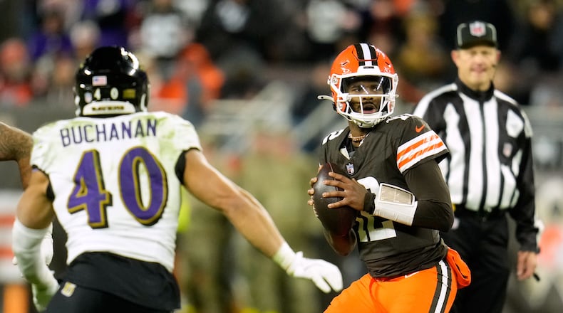 Cleveland Browns quarterback Shedeur Sanders (12) prepares to throw a pass under pressure from Baltimore Ravens linebacker Teddye Buchanan (40) in the second half of an NFL football game in Cleveland, Sunday, Nov. 16, 2025. (AP Photo/Sue Ogrocki)