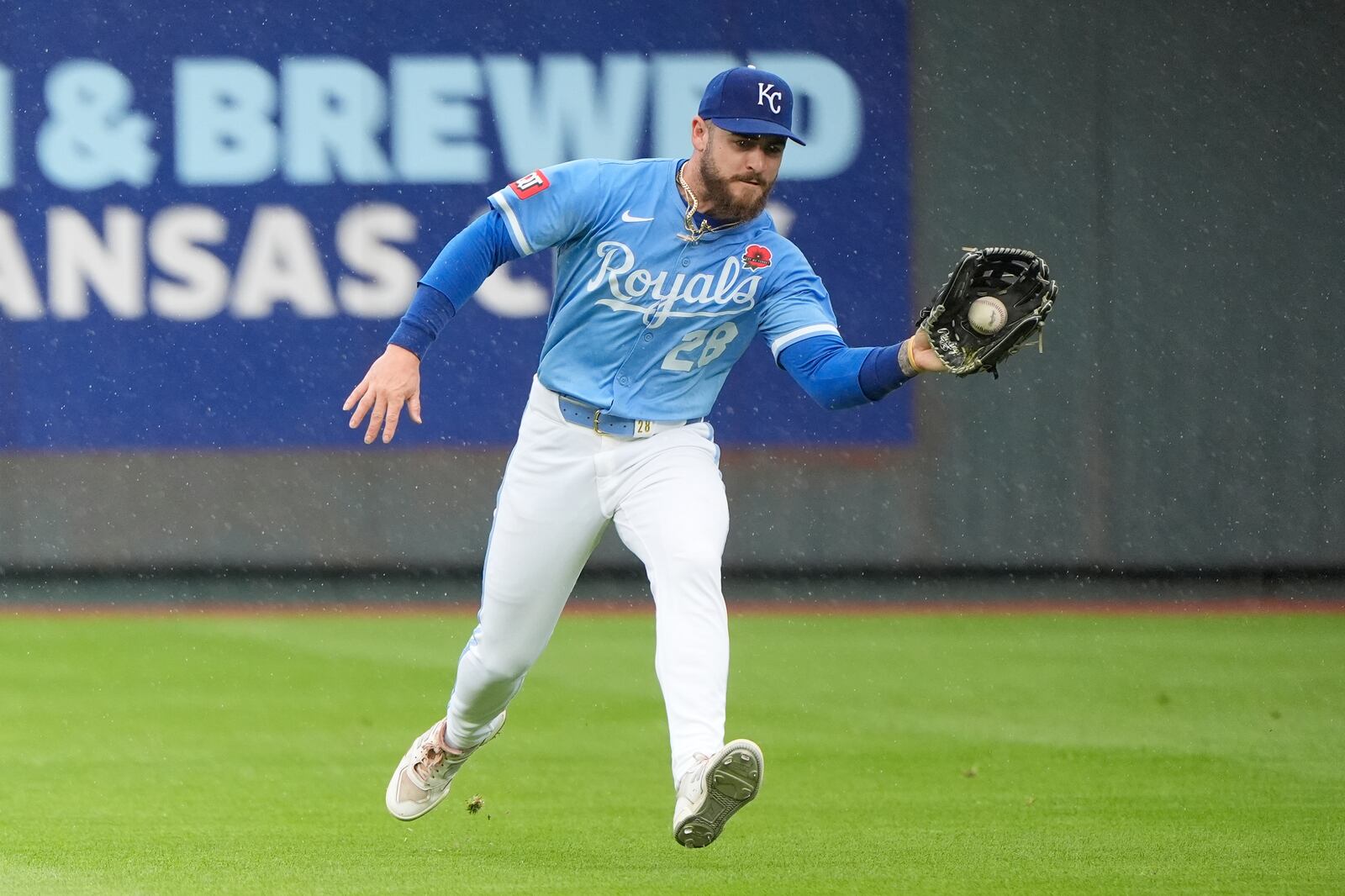 Kansas City Royals center fielder Kyle Isbel fields an RBI single hit by Cincinnati Reds' Gavin Lux during the third inning of a baseball game Monday, May 26, 2025, in Kansas City, Mo. (AP Photo/Charlie Riedel)