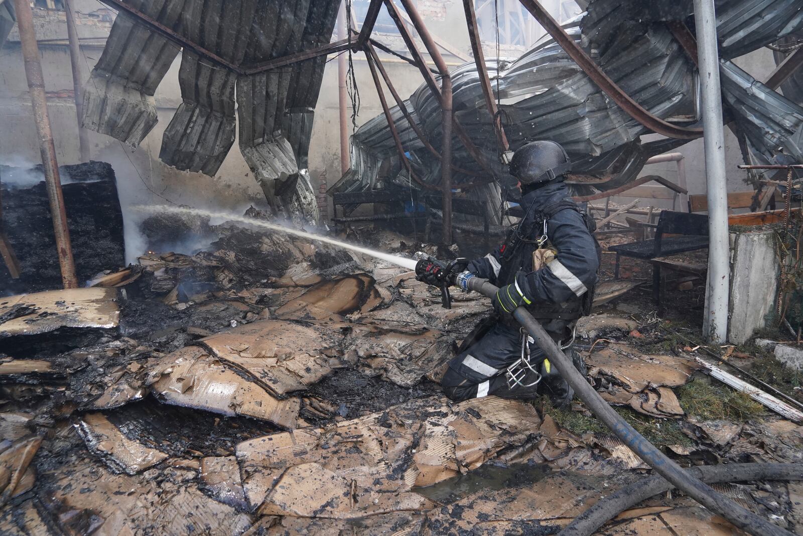 Firefighters tackle the blaze after a Russian attack that hit a residential area in Kharkiv, Ukraine, Thursday, July 24, 2025. (AP Photo/Andrii Marienko)