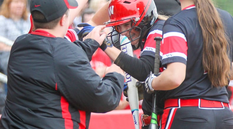 Lakota West’s Casey Bramble (6) is met by teammates after scoring a run against visiting Lakota East on April 11, 2017. GREG LYNCH/STAFF
