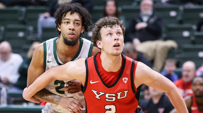 Youngstown State redshirt junior forward Rich Rolf, a Centerville native, boxes out Wright State's Logan Woods on a free-throw attempt during a Horizon League game on Thursday, Jan. 15 at Ervin J. Nutter Center in Fairborn. Rolf scored five points and had four rebounds in a 93-83 loss to the Raiders. BRYANT BILLING/STAFF
