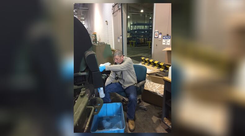 Gary Beckley, deputy director of the 88th Logistics Readiness Squadron, fills 32-oz. spray bottles May 12 with a weak bleach/water solution meant for disinfecting surfaces at Wright-Patterson Air Force Base. (Skywrighter photos/Amy Rollins)