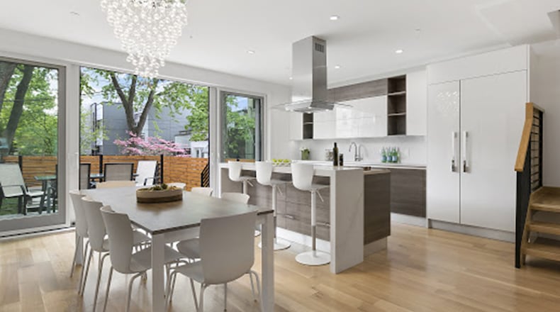 Pure white cabinets paired with a white table looks stunning when paired with wood. (Design Recipes)