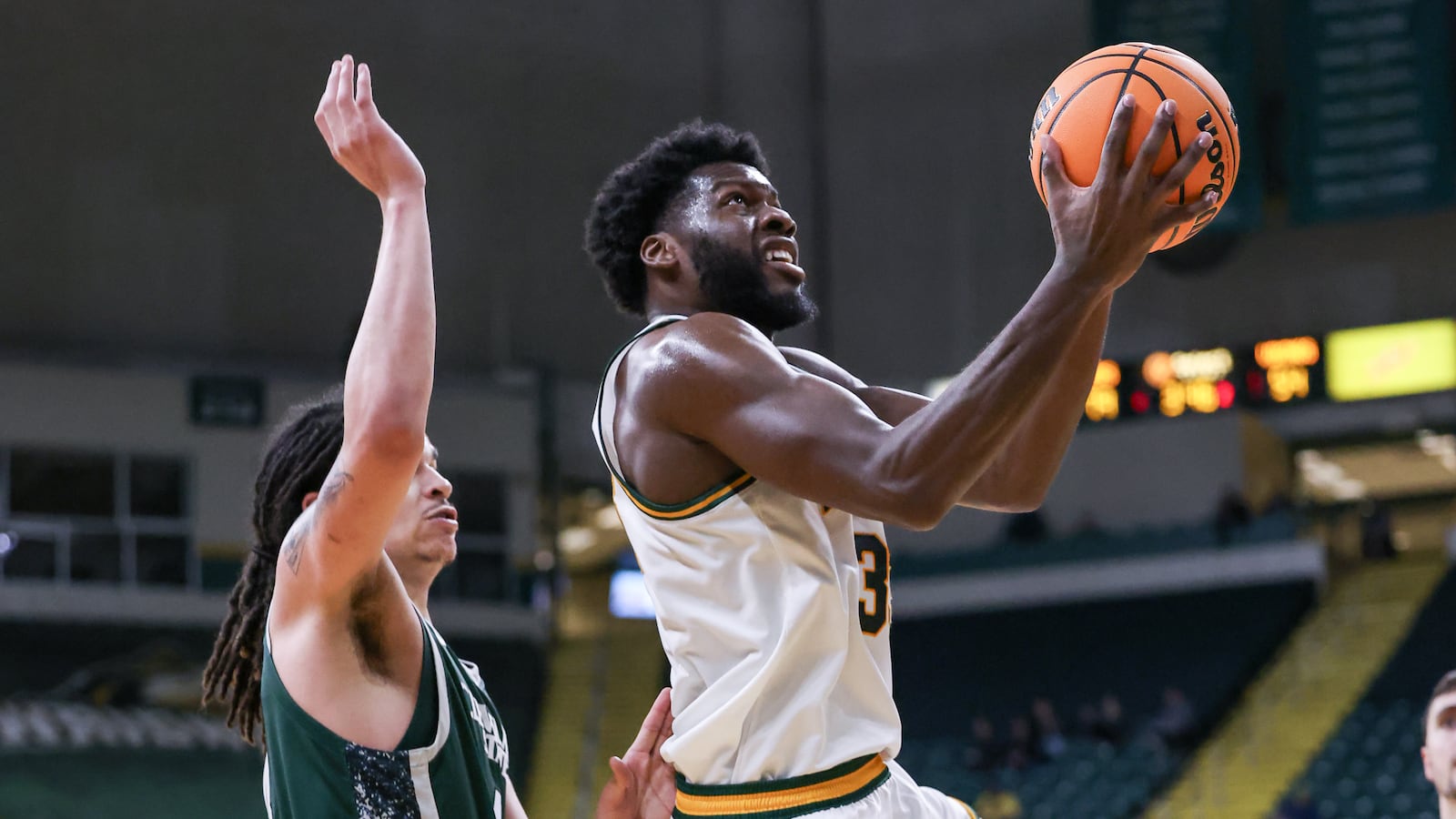 Wright State fifth-year senior forward Michael Imariagbe shoots with pressure from Cleveland State's Preist Ryan during a Horizon League Championship first-round game on Wednesday, March 4 at Ervin J. Nutter Center in Fairborn. Imariagbe scored 16 points and had five rebounds. BRYANT BILLING / STAFF
