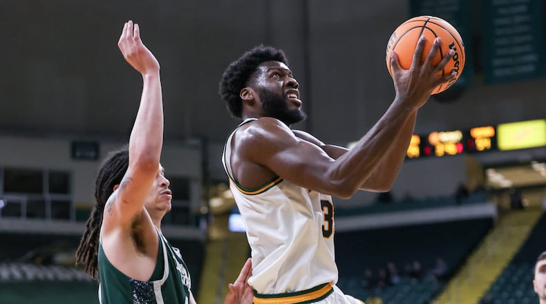 Wright State fifth-year senior forward Michael Imariagbe shoots with pressure from Cleveland State's Preist Ryan during a Horizon League Championship first-round game on Wednesday, March 4 at Ervin J. Nutter Center in Fairborn. Imariagbe scored 16 points and had five rebounds. BRYANT BILLING / STAFF