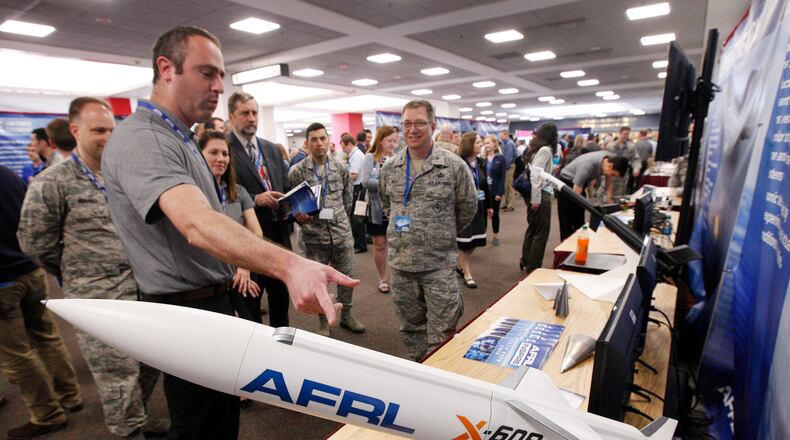 Barry Hellman, project manager for the Air Force Research Lab’s X-60A Hypersonic Research Vehicle, explains the project to AFRL personnel who were a part of the Inspire Tech Expo at the Dayton Convention Center in this May 2019 file photo.