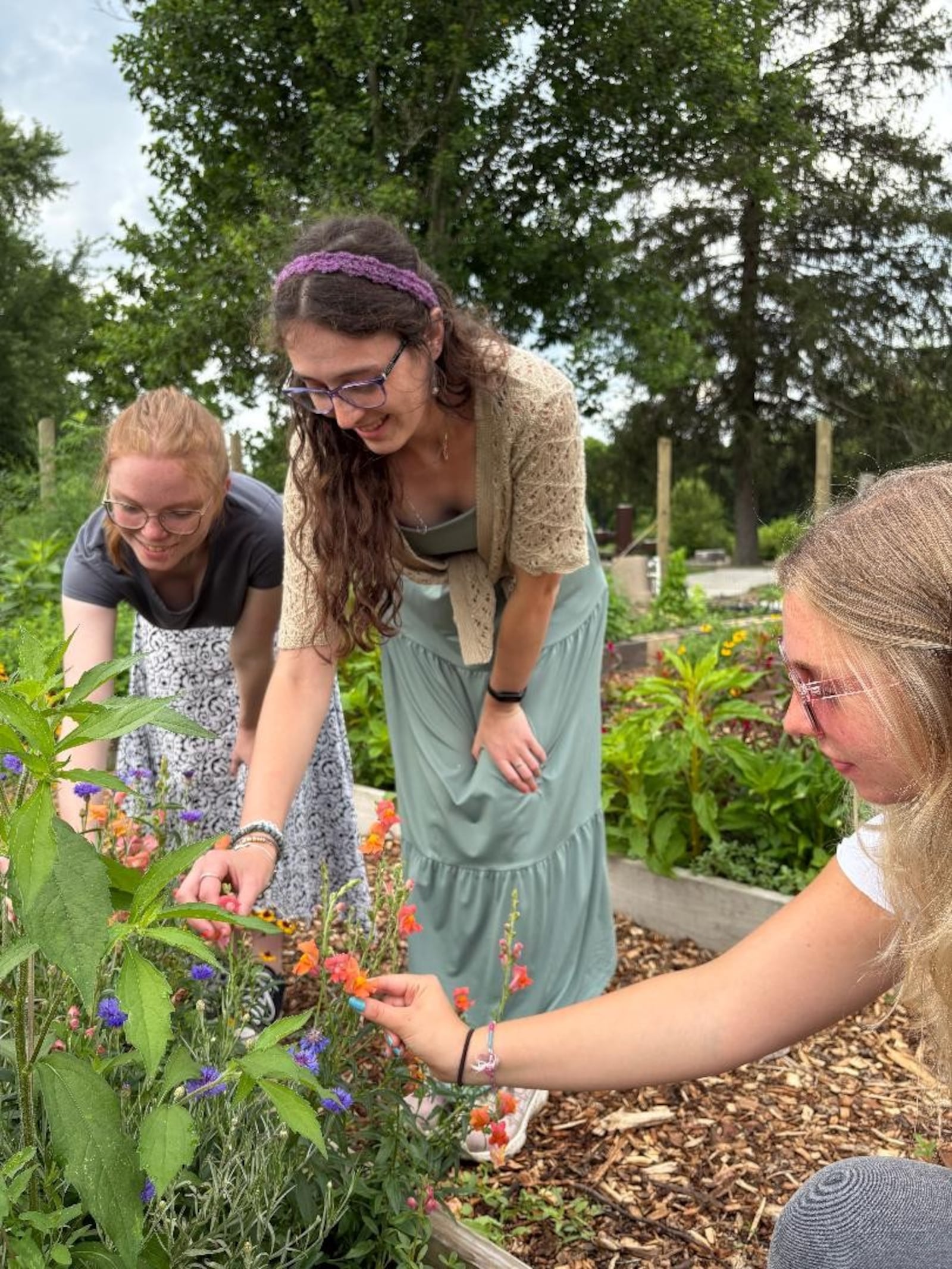 Left to right: University of Dayton students Hannah Scheuller, Shannon Dennemann and Grace Haas explore the demonstration garden at Possum Creek MetroPark. Photo by Russell Florence Jr.