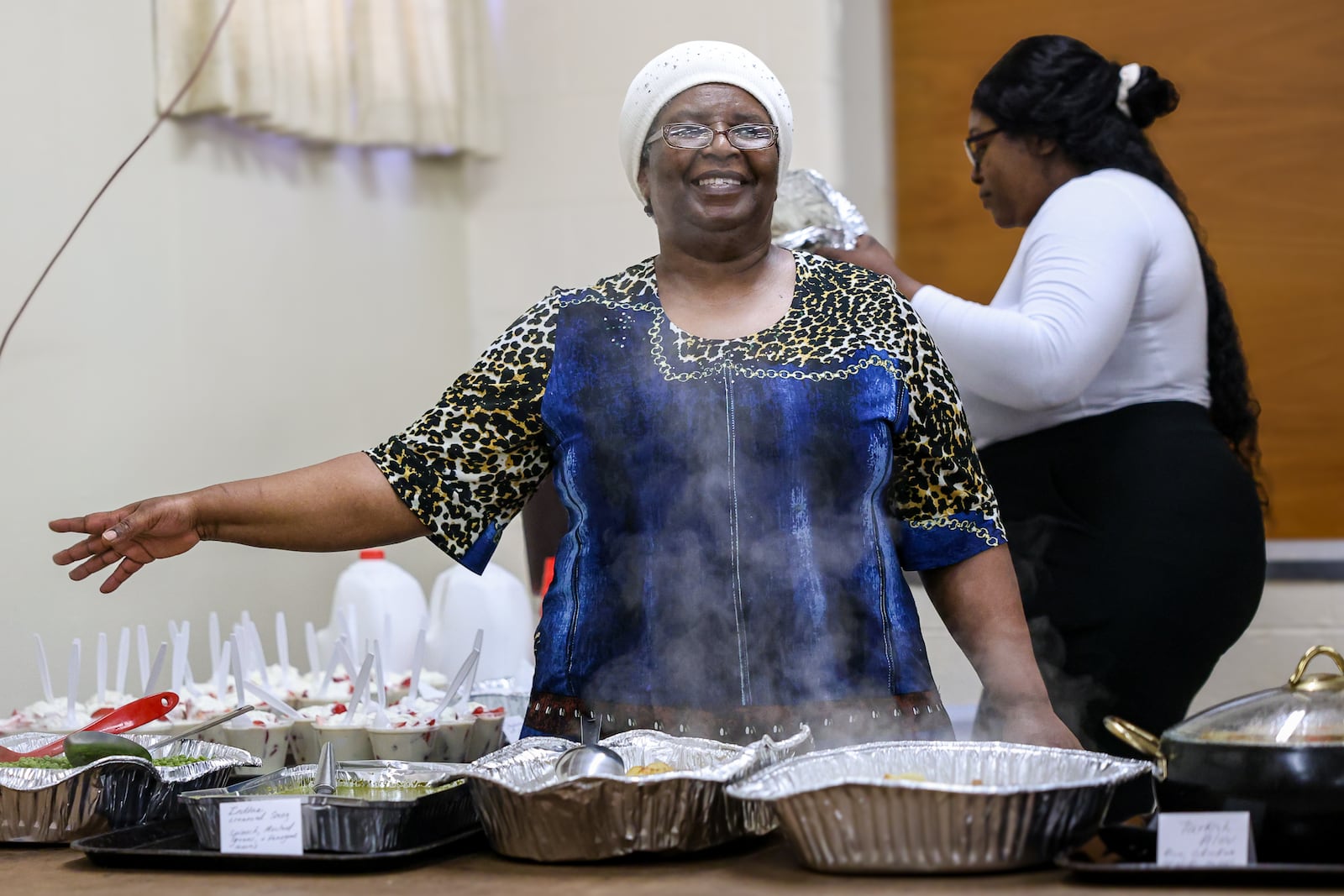 Catherine Bitwayiki, the director of Cross Over Community Development, explains food options during a lunch the organization hosted Tuesday at Christ Evangelical Lutheran Church in Dayton. The nonprofit has launched a new program to help immigrants build English skills and pursue careers in health care. Catherine Bitwayiki, the director of Cross Over Community Development, explains food options during a lunch the organization hosted Tuesday at Christ Evangelical Lutheran Church in Dayton. The nonprofit has launched a new program to help immigrants build English skills and pursue careers in health care. Bitwayiki talked about the program on Tuesday, and some immigrants in the program were in attendance. BRYANT BILLING / STAFF BRYANT BILLING / STAFF