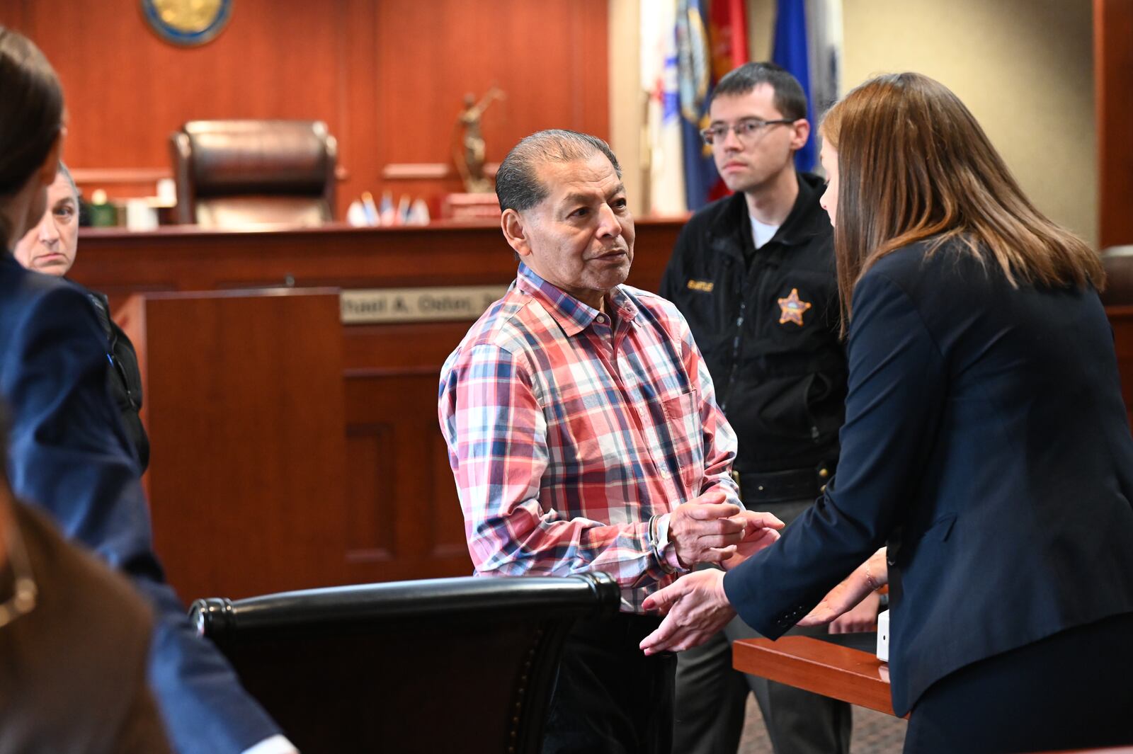 Antonio Riano is pictured in handcuffs talking with his attorney via an interpreter after he was found guilty of murder on Friday, June 13, 2025, in Butler County Common Pleas Court. The 63-year-old Mexican national was indicted in 2005 for the December 2004 shooting of Benjamin Becarra outside a Hamilton bar. MICHAEL D. PITMAN/STAFF