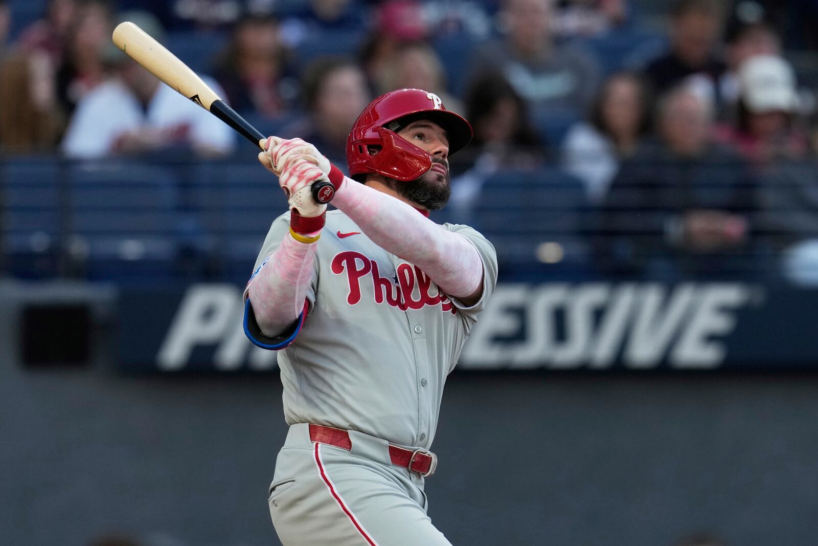 Philadelphia Phillies' Kyle Schwarber watches his home run in the second inning of a baseball game against the Cleveland Guardians in Cleveland, Sunday, May 11, 2025. (AP Photo/Sue Ogrocki)