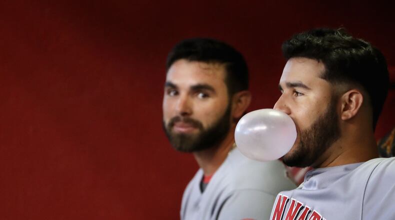 PHOENIX, AZ - JULY 09: Eugenio Suarez #7 (R) of the Cincinnati Reds blows a gum bubble alongside Jose Peraza #9 during the MLB game against the Arizona Diamondbacks at Chase Field on July 9, 2017 in Phoenix, Arizona. The Reds defeated the Diamondbacks 2-1. (Photo by Christian Petersen/Getty Images)