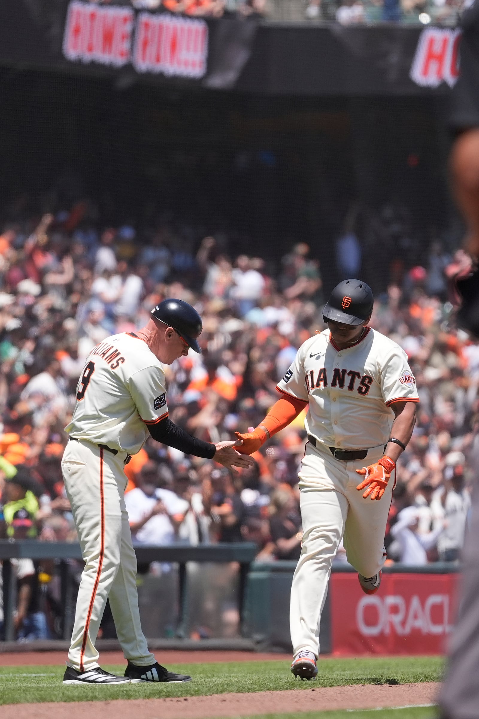 San Francisco Giants' Rafael Devers, right, is congratulated by third base coach Matt Williams after hitting a two-run home run during the third inning of a baseball game against the Boston Red Sox in San Francisco, Saturday, June 21, 2025. (AP Photo/Jeff Chiu)