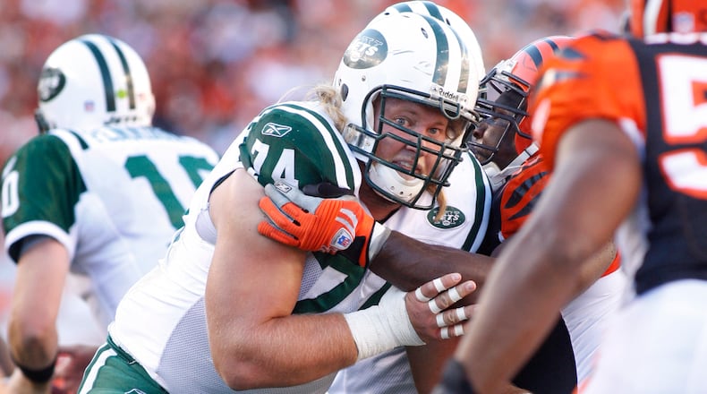 Nick Mangold, the starting center on the Jets offensive line, blocks for the Jets. Mangold graduated from Centerville High School and played for Ohio State.