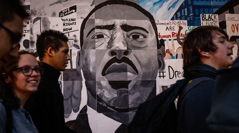 Northmont High School students walk by a painting of Dr. Martin Luther King Jr. in the foyer of the school Tuesday February 21, 2023. The Black student association put together an art exhibit showcasing Black history, which was put on display this month. JIM NOELKER/STAFF