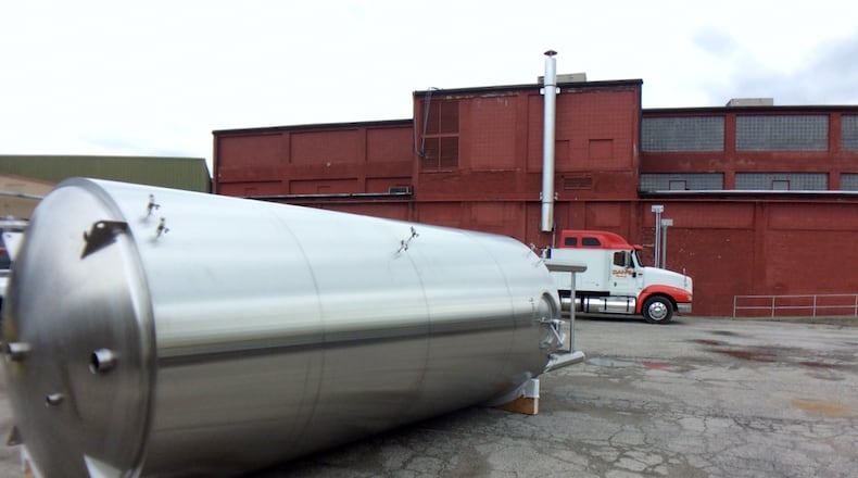 One of the new 120-barrel fermentation tanks awaiting installation Thursday afternoon outside Warped Wing Brewing Company. MARK FISHER/STAFF