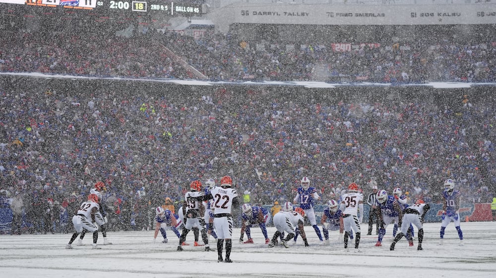 Snow falls as the Buffalo Bills line up for a play against the Cincinnati Bengals during the first half of an NFL football game, Sunday, Dec. 7, 2025, in Orchard Park, N.Y. (AP Photo/Gene J. Puskar)