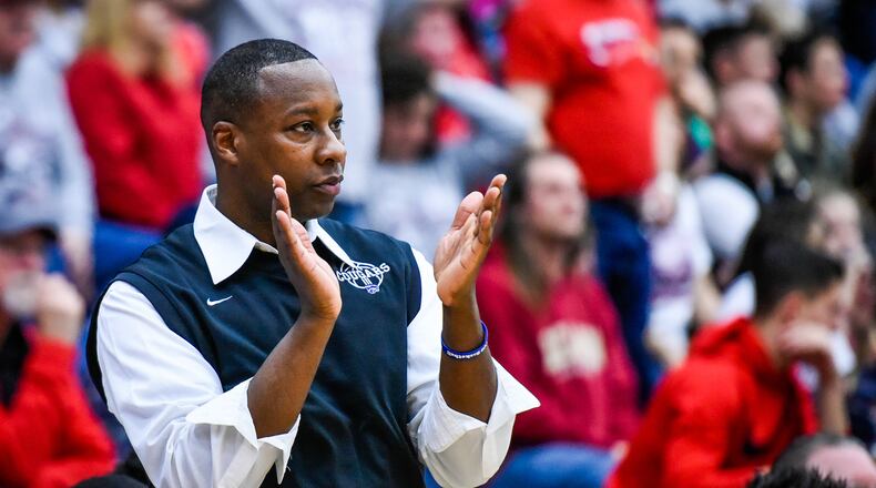 Cincinnati Christian coach Carl Woods cheers on his team during their 57-44 loss to Lima Perry in a Division IV regional final March 17, 2017 at Fairmont’s Trent Arena. NICK GRAHAM/STAFF