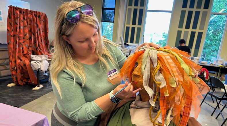Melinda Montgomery works on her family's version of the famous Mona Lisa painting that will be part of the annual Project Scare-a-Crow display in National Road Commons Park that will go up on Friday, Oct. 3. The 2025 theme is Iconic Works of Art. They will be on display during ChalkFest in the park on Saturday, Oct. 4 and through Oct. 24. CONTRIBUTED