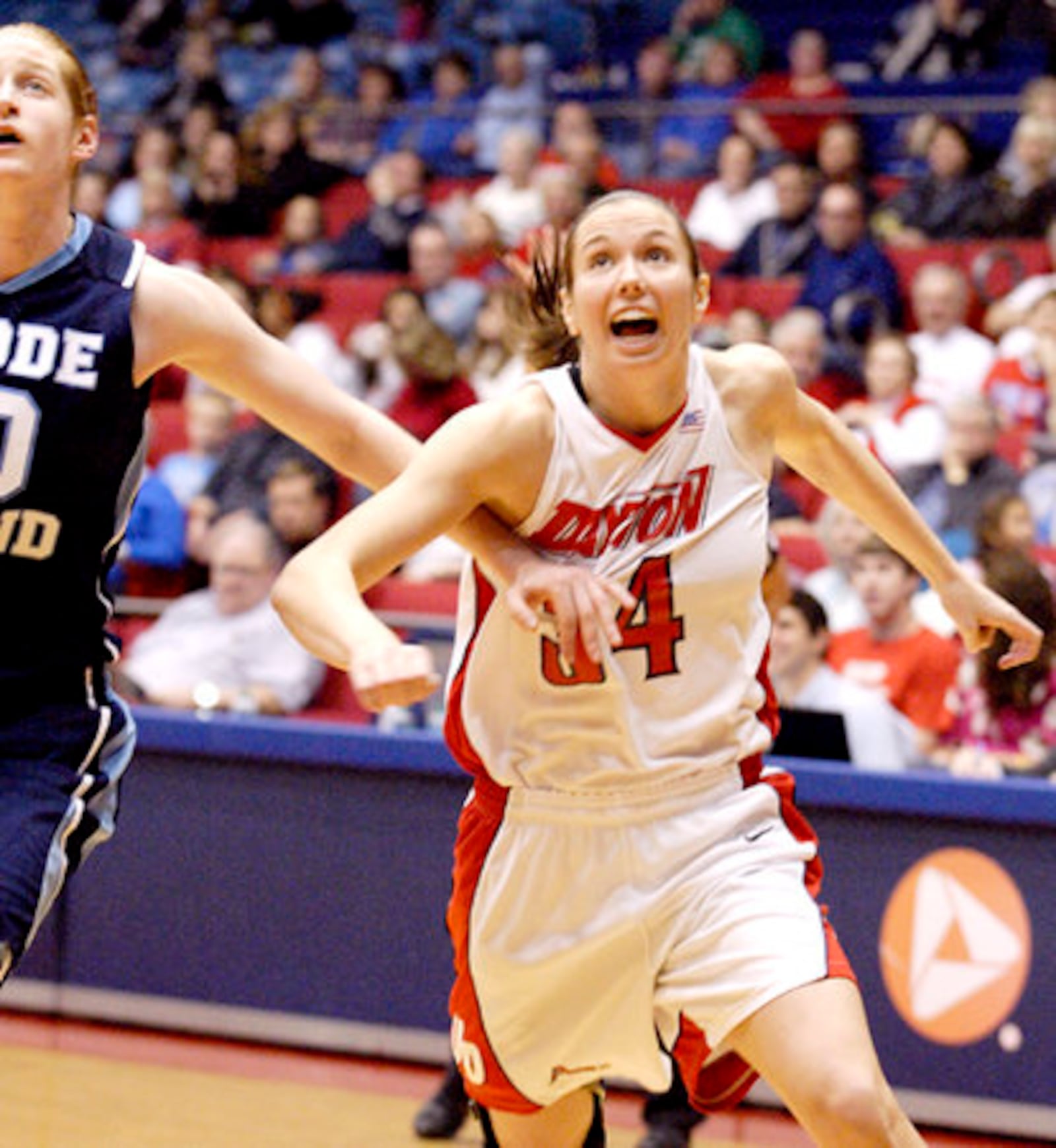Rhode Island sophomore Emilie Cloutier (20) and UD senior Justine Raterman (34) battle for position Saturday, Jan. 7, at UD Arena.