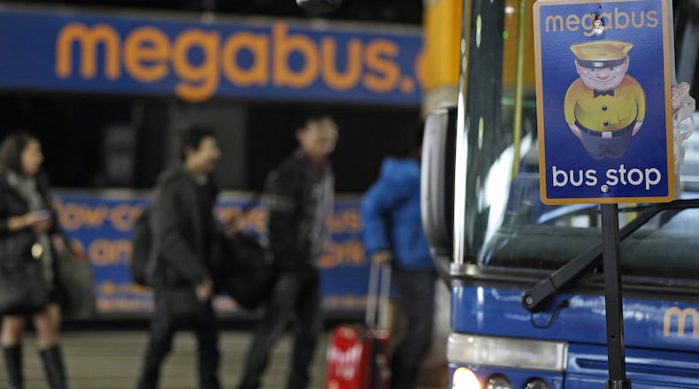 Passengers wait to board a Megabus in Washington, D.C.,on Jan. 4, 2013. (Photo: Rich Clement/Bloomberg)