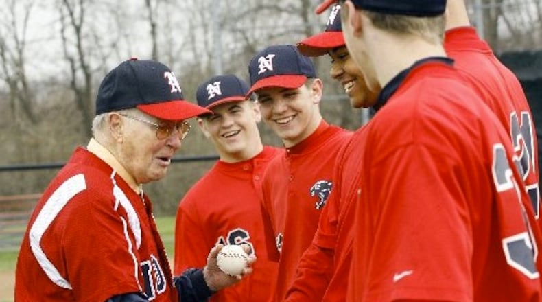 Former North baseball coach Don Henderson shakes hands with the current players after throwing out a ceremonial first pitch to his former player, North assistant Doug Stoll, before North played Northwestern in the Panther Classic Saturday, April 12, 2008. Staff Photo by Barbara J. Perenic