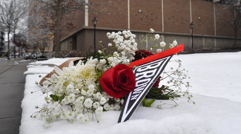 A bouquet of flowers rests on snow, Sunday, Dec. 14, 2025, on the campus of Brown University not far from where a shooting took place, in Providence, R.I. (AP Photo/Steven Senne)