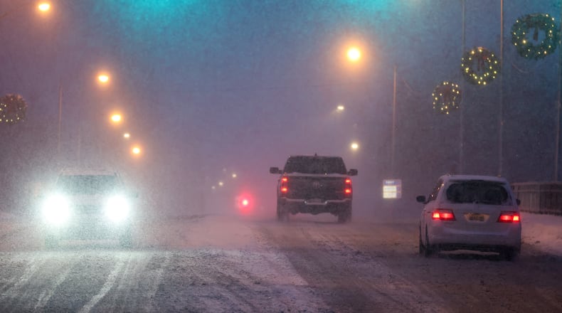 Vehicles drive on North Market Street in Troy on Dec. 13. Troy received over five inches of snow that day. BRYANT BILLING/STAFF