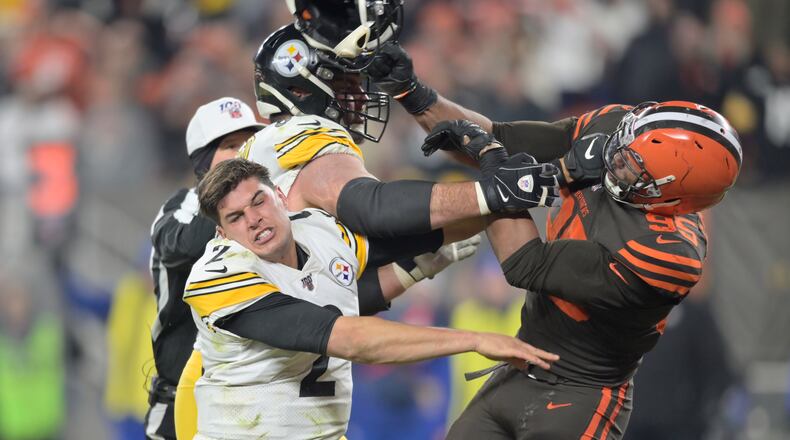 Cleveland Browns defensive end Myles Garrett swings a helmet at Pittsburgh Steelers quarterback Mason Rudolph (2) late in the fourth quarter of an NFL football game against the Pittsburgh Steelers, Thursday, Nov. 14, 2019, in Cleveland. The Browns won 21-7. (AP Photo/David Richard)