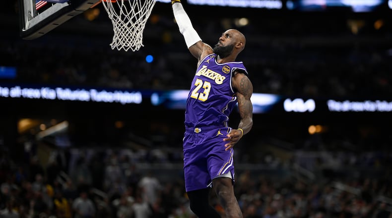 Los Angeles Lakers forward LeBron James (23) scores on a breakaway dunk during the first half of an NBA basketball game against the Orlando Magic, Saturday, March 21, 2026, in Orlando, Fla. (AP Photo/Phelan M. Ebenhack)