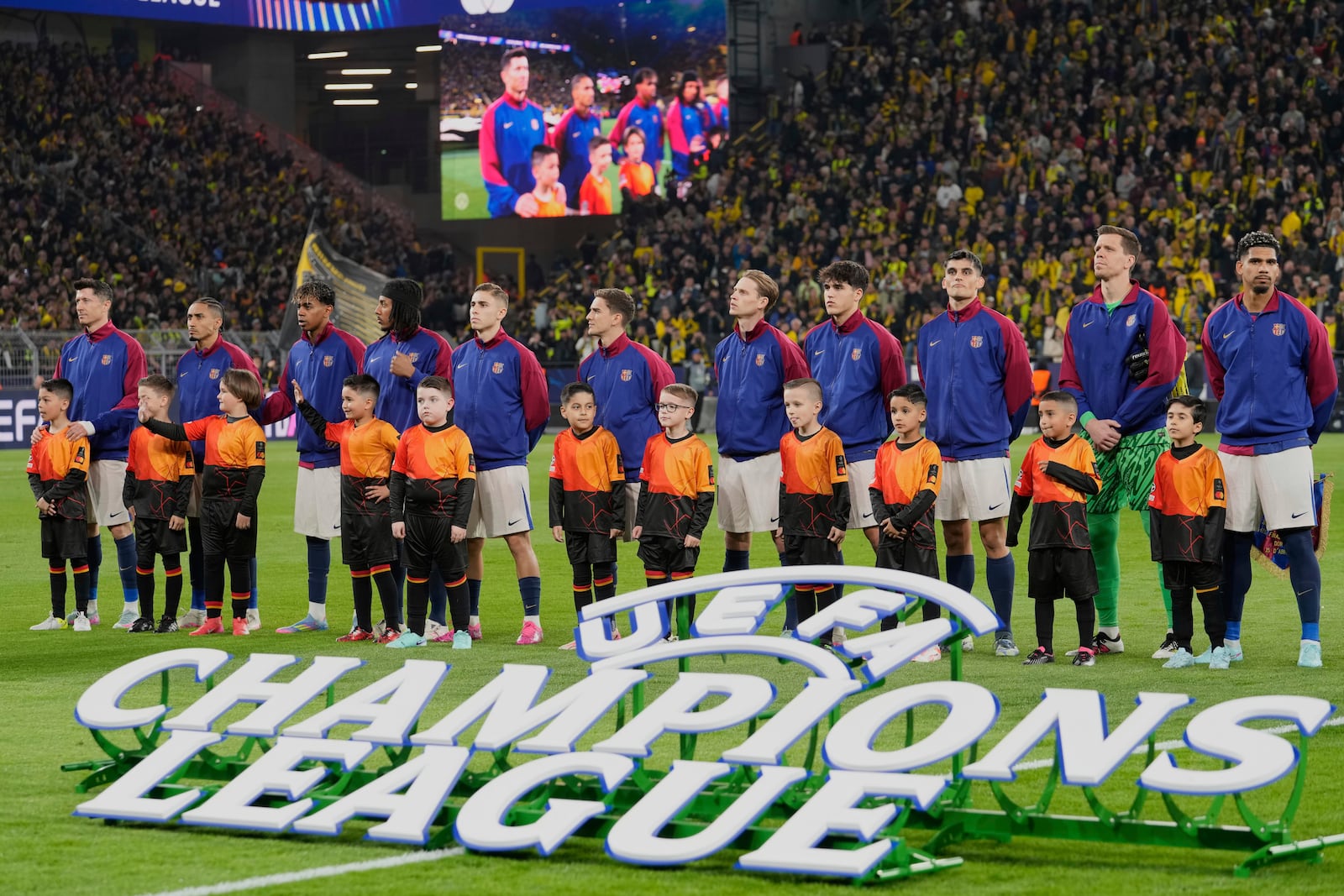 Barcelona players ahead of the Champions League quarterfinals second leg soccer match between Borussia Dortmund and Barcelona, at the Signa-Iduna Park in Dortmund, Germany, Tuesday, April 15, 2025. (AP Photo/Martin Meissner)