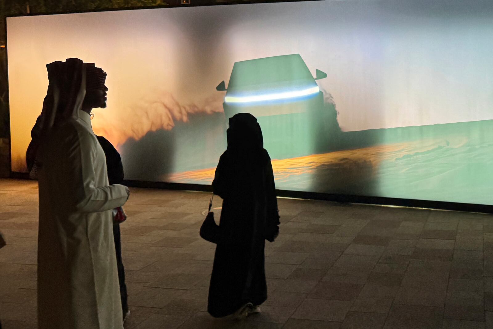 People attend a celebration for the start of Tesla operations in Saudi Arabia in historic Diriyah near Riyadh, Saudi Arabia, on Thursday, April 10, 2025 (AP Photo/Baraa Anwer)