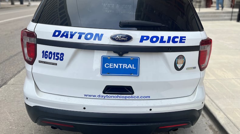 A Dayton Police Department cruiser parked outside of City Hall. CORNELIUS FROLIK / STAFF