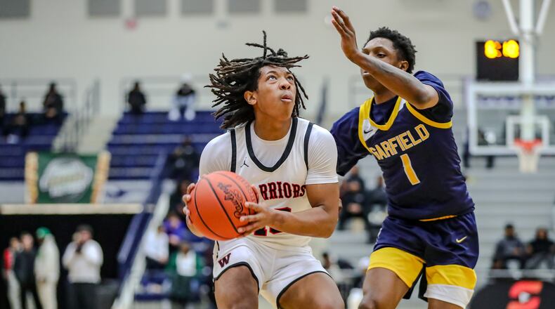 Wayne High School senior Jay'Sean Price is guarded by Garfield Heights senior Devaughn Jackson during their game earlier this year at The Beacon Orthopaedics Flyin' to the Hoop Invitational at Kettering's Trent Arena. MICHAEL COOPER/CONTRIBUTED
