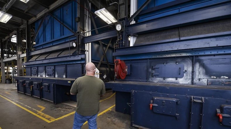 Michael McShirley, an 88th Civil Engineer Squadron stationary engineer, inspects the Kaufman Avenue heat plant’s biggest boilers in this 2021 photo. The two boilers are capable of putting out as much as 120,000 pounds each of steam every hour and are partly responsible for heating Area B of Wright-Patterson Air Force Base. (U.S. Air Force photo by Wesley Farnsworth)