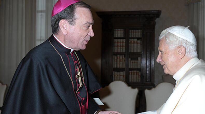 Pope Benedict XVI greets Archbishop Dennis M. Schnurr of Cincinnati during a Feb. 2 meeting with U.S. bishops on their "ad limina" visits to the Vatican. U.S. bishops from Ohio were making their "ad limina" visits to report on the status of their dioceses to the pope and Vatican officials. (CNS photo/L'Osservatore Romano) (Feb. 2, 2012)
