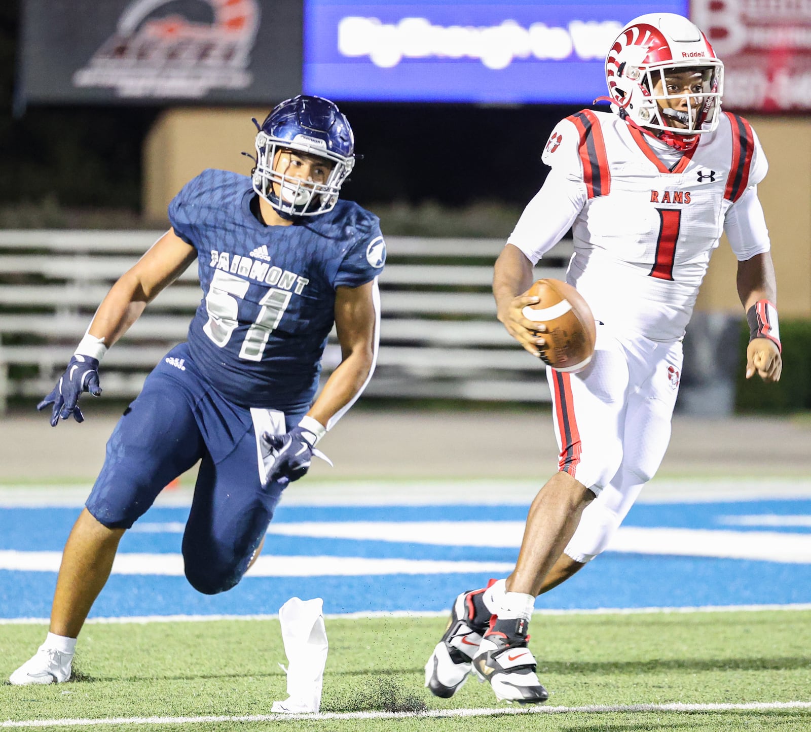 Trotwood-Madison senior quarterback Dallas Shehee runs with pressure from Fairmont's Michael Newsom during a nonconference game on Friday, Aug. 29 at Roush Stadium in Kettering. BRYANT BILLING / STAFF