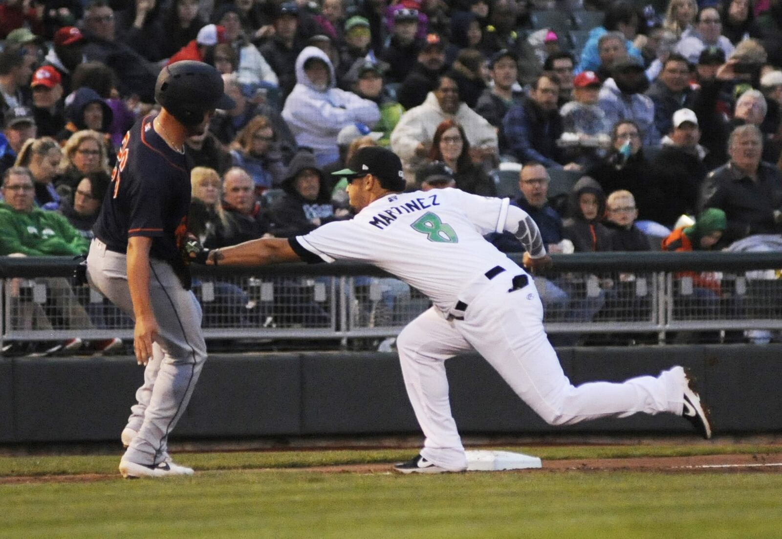 Dragons third baseman Juan Martinez tags out Chris Betts, who mistakingly thought there were already three outs in the third inning. Dayton hosted Bowling Green in a minor-league baseball season opener at Fifth Third Field on Thursday, April 4, 2019. MARC PENDLETON / STAFF