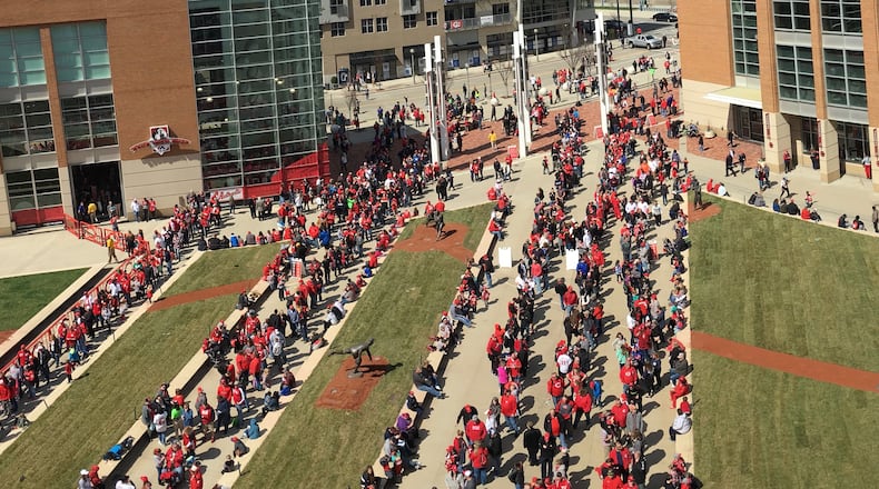 Fans wait in line to get into Great American Ball Park before a game between the Reds and Nationals on Saturday, March 31, 2018, in Cincinnati. David Jablonski/Staff
