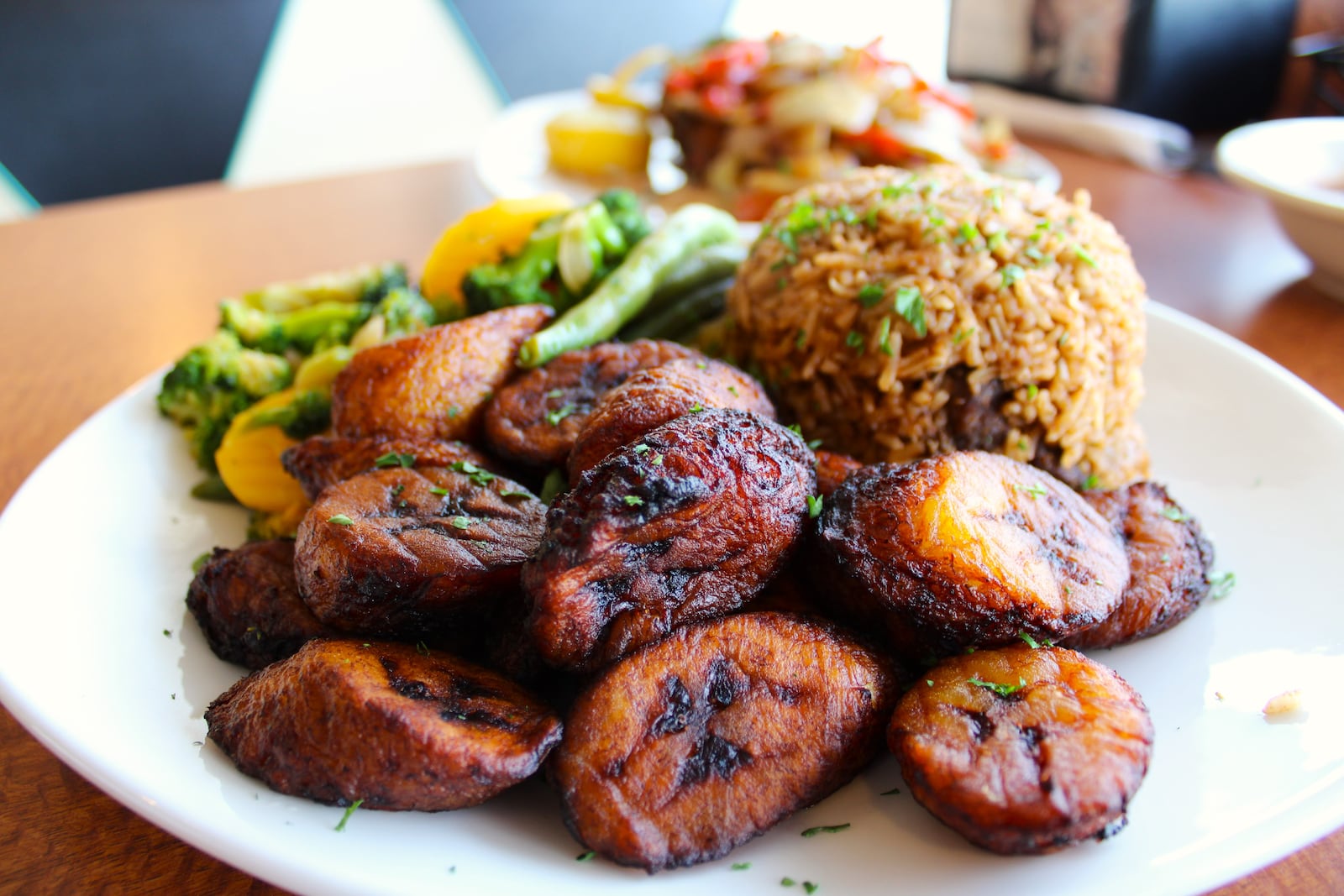 Fried plantains, pilau rice and a vegetable medley fill a plate at SoSo Cuisine, which offers East African traditional dishes. STAFF/SYDNEY DAWES