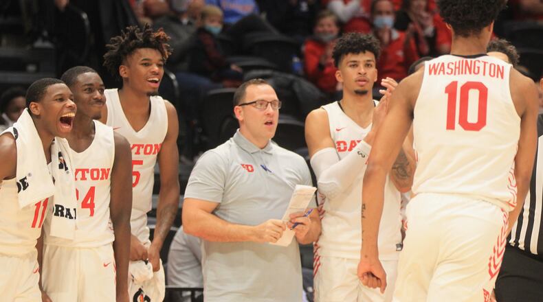 Dayton players and coach Andy Farrell, center, react, after a dunk by Kaleb Washington against Cedarville in an exhibition game on Monday, Nov. 1, 2021, at UD Arena. David Jablonski/Staff