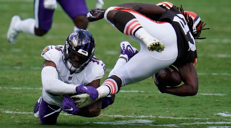 Baltimore Ravens safety Chuck Clark (36) grabs Cleveland Browns running back Kareem Hunt's (27) foot, during the second half of an NFL football game, Sunday, Sept. 13, 2020, in Baltimore, MD. (AP Photo/Julio Cortez)
