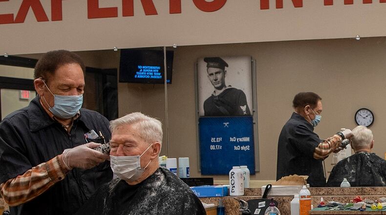 Richard Roe cuts the hair of a customer Feb. 5 at the Wright-Patterson Air Force Base Barber Shop. Meeting new people and being around the Air Force has kept him coming back to work for more than four decades, he says. U.S. AIR FORCE PHOTO/AIRMAN 1ST CLASS ALEXANDRIA FULTON