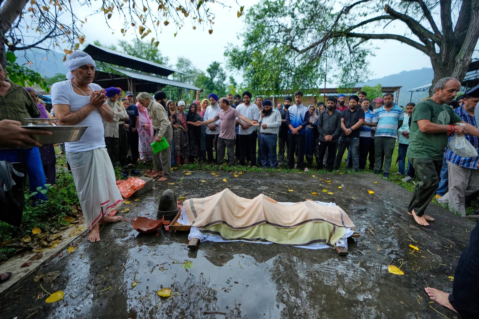 Sanjeev Barghava, left, performs the last rites of his son Vihaan Barghava, 30, killed in Pakistani artillery shelling in Poonch along the Line of Control, Indian controlled Kashmir, Thursday, May 8, 2025. (AP Photo/Channi Anand)