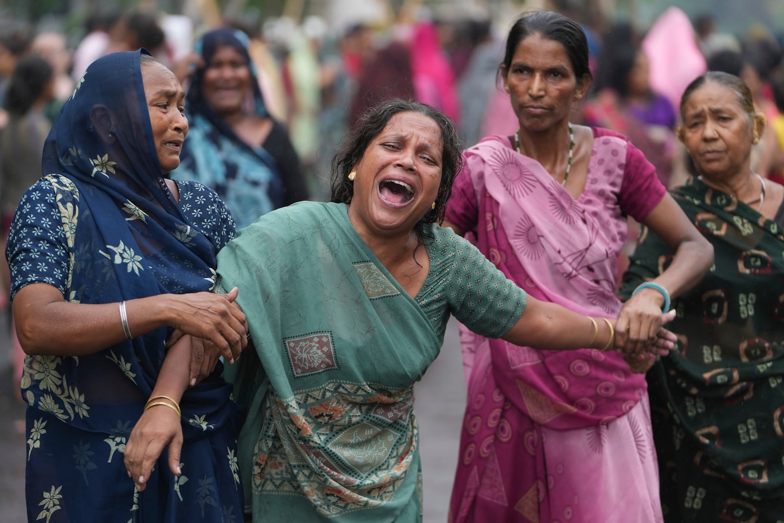 Relatives of Akash Patni, victim of the Air India plane crash, grieve during his funeral procession in Ahmedabad, India, Tuesday, June 17, 2025. (AP Photo/Ajit Solanki)