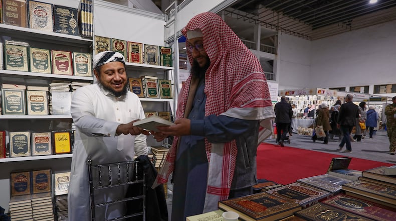 A visitor looks through a book at a stall selling Islamic titles during the 57th Damascus International Book Fair in Damascus, Syria, Monday, Feb. 16, 2026, the first edition since the collapse of the Assad regime. (AP Photo/Omar Sanadiki)